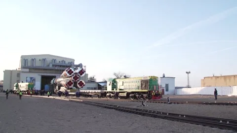 Train towing Russian spacecraft Soyuz 2.1a out of integration building, Baikonur Video stock 273698014
