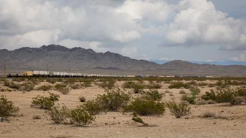 The train track with endless rows of wagons in the desert Stock Photos