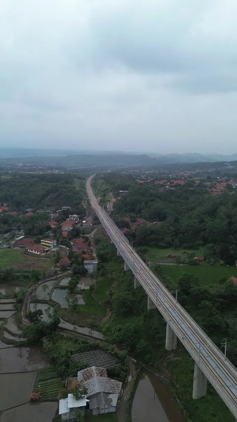 Train track over settlements and rice fields Stock Footage 293258346