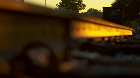 Train track rail at sunset with boxcar in focus Stock Footage 41818004