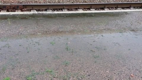 A train track is shown with water on the ground 動画素材 273991720