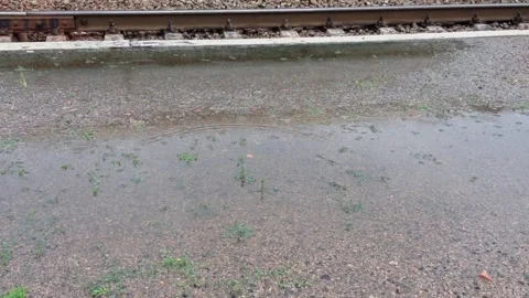 A train track is shown with water on the ground 動画素材 274028600
