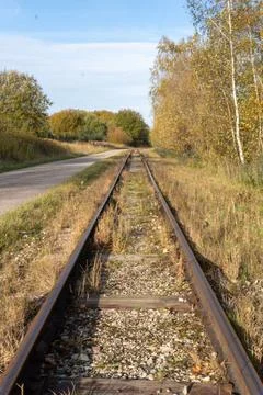 The train tracks are empty and the grass is dry Stock Photos
