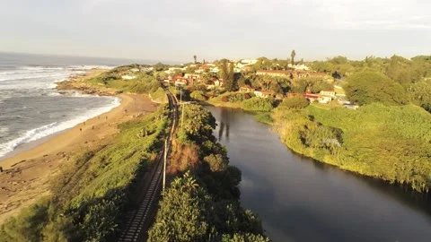 Train tracks between ocean and lagoon - Port Shepstone, South Africa Video stock 197463581