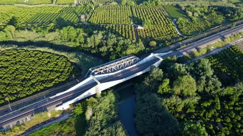 Train tracks go over river through a truss bridge. Stock-Footage 258288321