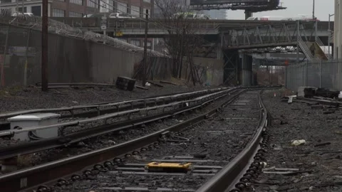 Train tracks that go under a bridge with cars going over Stock Footage 131681647