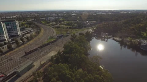 Train on tracks going toward a river aerial 4k Stock Footage 278253222