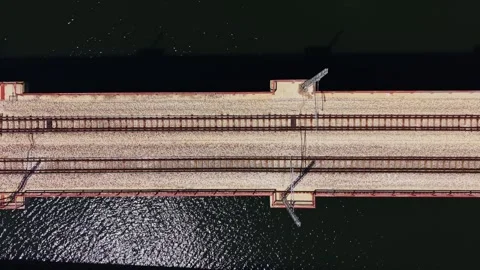 Train tracks run across the bridge over the water on a sunny day Stock Footage 338276429