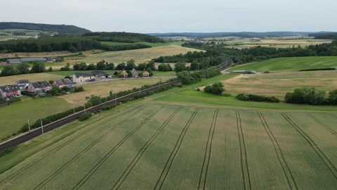Train tracks winding through green fields Stock Footage 244205593