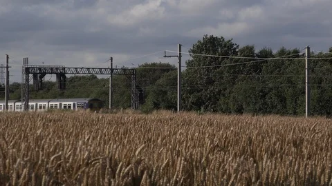 Train travel commuting through farm fields England countryside UK 4K 스톡 동영상 112970601