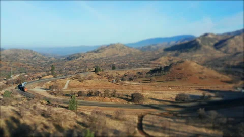 Train traveling along the Tehachapi Loop Union Pacific tracks - tilt shift Video stock 149102074
