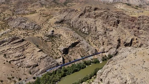 A train is traveling down a river in a hill Stock Footage 327854484