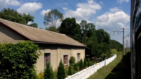 A train is traveling down a track next to a field Stock Footage 271389681