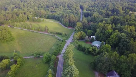 A train traveling down train tracks near a forest Stock Footage 156338715