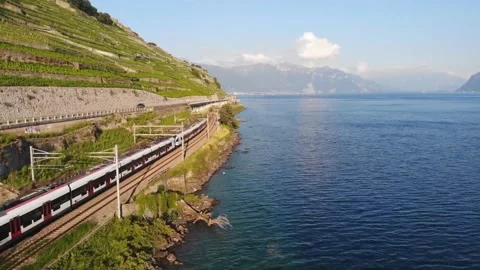 Train traversing terraced vineyards alongside Lake Geneva, Switzerland. Stock Footage 302311596