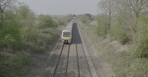 Train in Tree Lined English Countryside Stock Footage 49356312