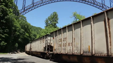 Train Treks Under Huge Bridge Stock Footage 44474222