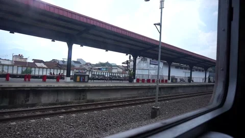 Train view from the train window with lush green trees and calm cloudy sky. Stock Footage 332855760