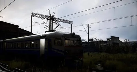 Train waits at the deserted platform under a cloudy sky in the evening Stock Illustration