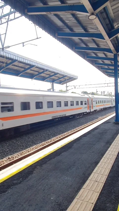 Train waits at station platform under twilight sky Stock Footage 340142873