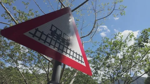 Train Warning Road Sign in Dappled Sunlight among Forest Trees Stock Footage 340414313