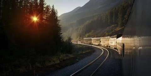 Train Winding Through Mountains At Sunset Stock Photos
