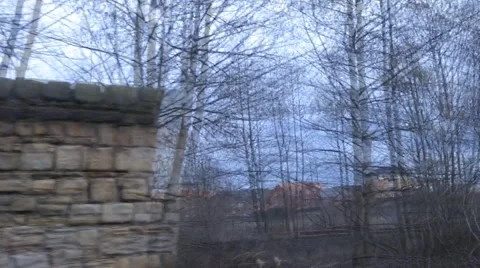 From train window on inner city tracks, under bridge approach station Stock Footage 1099968