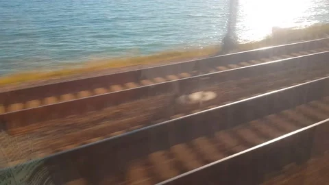 Train window of the rails along the seashore, a first-person train Stock Footage 167159076