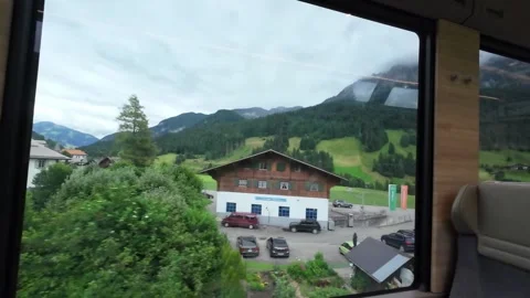 Train Window View of Alpine Valley and Green Meadows Stock Footage 340369011