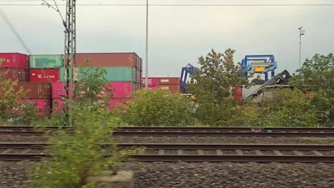 Train window view of a container terminal with colorful freight containers .. Vídeos de archivo 344673831