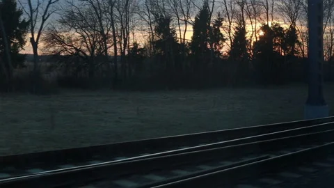 Train window view with dramatic sunset light Stock Footage 112002124
