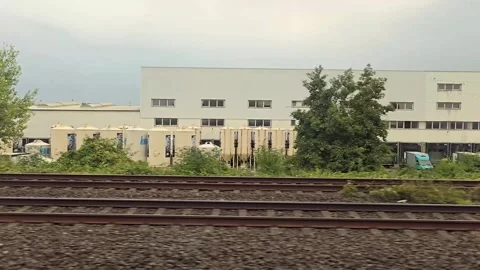 Train window view of an industrial warehouse complex with silos and Danogip.. Stock Footage 344673669