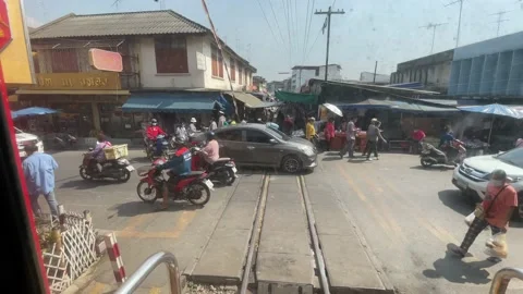 Train window view local umbrella market (Talad Rom Hub). People shopping Stock Footage 196269285