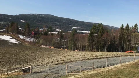 Train Window View of Norwegian Fields, Forests, and Hills in Early Spring Stockbeeldmateriaal 340583180