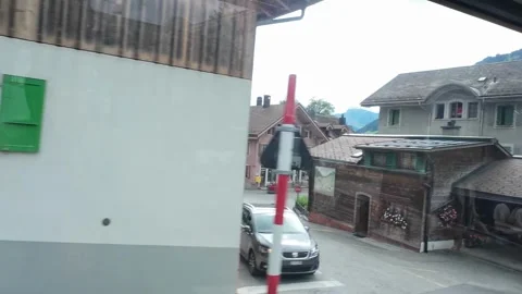 Train Window View Passing Wooden Chalet and Parked Van Stock Footage 340368112