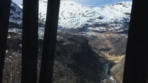 Train Window View of Snowy Mountains and Valley on Flam Railway in Norway Stock Footage 340877397