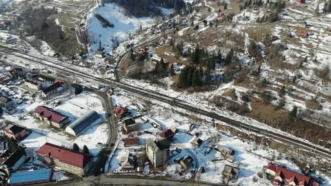 Train winter mountains drone Ukraine carpathian mountains railway station Stock Footage 124358537