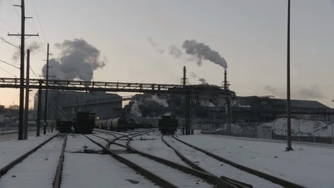Train yard with Factory smoke in background Pan Left Stock Footage 89945275