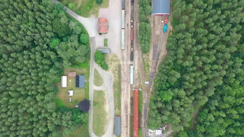 Train yard in a forest, aerial view of tracks, trains &amp; depo Stock Footage 164522078
