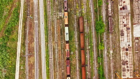 Train yard with numerous railway tracks and freight cars located in an Stock Footage 340950578