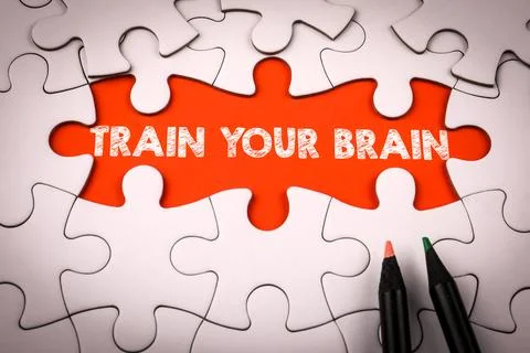Train Your Brain Text Revealed Through Puzzle Pieces Concept Stock Photos
