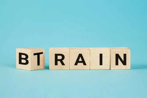 Train Your Brain. Turns a cube and changes the word 'train' to 'brain' on wooden Stock Photos