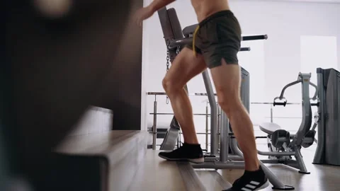 The trained bodybuilder, after a hard training, goes out on the stairs, out of Stock Footage 156866957
