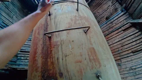 A trained guy climbs up a ladder welded to a pipe. A dangerous trick. Stock Footage 314521517