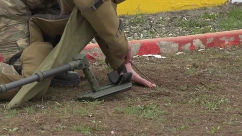 Trained man Is Looking For anti Tank and anti-personnel Mines Stock Footage 237447919