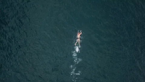 Trained man swims in open water in the sea Stock Footage 99365145