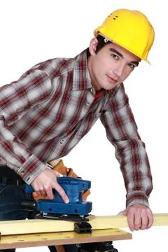 A trainee handling a jigsaw. Stock Photos