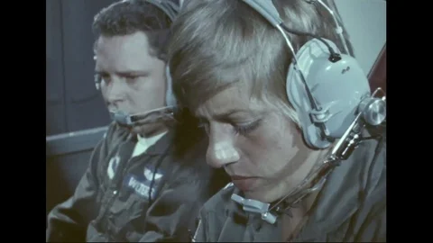 Trainee pilot operates controls in cockpit under guidance of instructor - 1976 Stock Footage 103746846