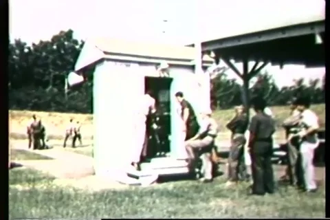Trainee practice target drill with pistol in open field - 1965 Stock Footage 106067615