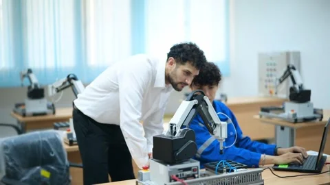 Trainee Robotics engineer learning with Programming and Manipulating Robot Ha Stock Footage 280790068